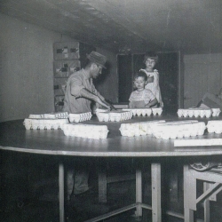 Paul, Mark, and Dixie packing eggs